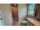 Bright bathroom with a tiled shower, granite countertops, and wood-look tile flooring at 2132 Nordendale Blvd, North Port, FL 34288