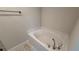 Bright bathroom featuring a soaking tub, modern fixtures, and neutral color palette at 2132 Nordendale Blvd, North Port, FL 34288