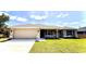Charming single-story home with a well-manicured lawn, two car garage, and neutral color palette at 2132 Nordendale Blvd, North Port, FL 34288