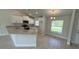 Bright kitchen featuring white cabinetry, granite countertops, stainless steel appliances, and tile flooring at 2132 Nordendale Blvd, North Port, FL 34288