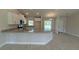 Open-concept kitchen with granite countertops, stainless steel appliances, and light wood-look tile flooring at 2132 Nordendale Blvd, North Port, FL 34288