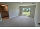 Main bedroom with a window, carpet flooring, and ensuite bathroom at 2132 Nordendale Blvd, North Port, FL 34288