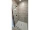 Tiled shower with glass door and modern fixtures at 2132 Nordendale Blvd, North Port, FL 34288