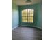 Bedroom with a large window offering lots of natural light, and hard wood floors at 5152 Northridge Rd # 302, Sarasota, FL 34238