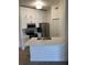 Modern kitchen with white cabinets, stainless steel appliances, and a quartz countertop breakfast bar at 5152 Northridge Rd # 302, Sarasota, FL 34238