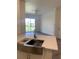 Open-concept kitchen overlooking the living area with a stainless steel sink and modern finishes at 5152 Northridge Rd # 302, Sarasota, FL 34238
