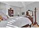 Bright bedroom with a wood dresser, hardwood floors, and a tall coat rack, with lots of natural light at 7235 Rangi Dr, Sarasota, FL 34241