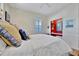A cozy bedroom featuring a built-in desk and shelving nook with a vibrant red accent wall adding a pop of color at 7235 Rangi Dr, Sarasota, FL 34241