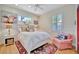 Charming bedroom with a plush rug, white furniture, and ample natural light from the window with plantation shutters at 7235 Rangi Dr, Sarasota, FL 34241