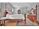 Sunlit bedroom featuring hardwood floors, a ceiling fan, and a beautifully crafted wood bed frame and dresser at 7235 Rangi Dr, Sarasota, FL 34241