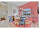 Bright dining area with colorful chandelier, round table, and seating for four at 7235 Rangi Dr, Sarasota, FL 34241
