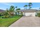 Charming single-story home with well-manicured lawn, lush landscaping, and a two-car garage at 7235 Rangi Dr, Sarasota, FL 34241