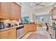 Kitchen featuring granite countertops, wood cabinets, and views of the dining area at 7235 Rangi Dr, Sarasota, FL 34241