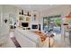 Comfortable living room with fireplace, built-in shelves, and sliding doors to the patio and pool at 7235 Rangi Dr, Sarasota, FL 34241