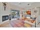 Spacious living room featuring a fireplace, access to a patio, and views of the kitchen at 7235 Rangi Dr, Sarasota, FL 34241