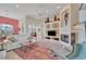 Open-concept living room features a fireplace, tile floors, and comfortable seating with views to dining area at 7235 Rangi Dr, Sarasota, FL 34241