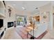 Open living room with a fireplace, tile floors, and sliding glass doors leading to outdoor patio at 7235 Rangi Dr, Sarasota, FL 34241