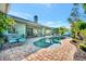 Pool with patio and covered outdoor spaces, lush landscaping, and blue skies on the exterior at 7235 Rangi Dr, Sarasota, FL 34241