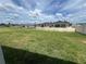 Expansive backyard view showing a well-maintained lawn and neighboring homes in the community at 766 Hillshire Pl, Spring Hill, FL 34609