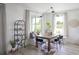 Bright dining area with large windows, modern lighting, a stylish table, and a cozy built-in bench with throw pillows at 766 Hillshire Pl, Spring Hill, FL 34609