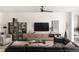 Inviting living room featuring a comfortable sofa, stylish decor, a contemporary entertainment center, and plenty of natural light at 766 Hillshire Pl, Spring Hill, FL 34609