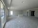 Bright, open-concept living room featuring large windows for natural light and ample space for customization at 766 Hillshire Pl, Spring Hill, FL 34609
