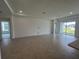 Bright and airy living room with tile flooring, recessed lighting, neutral walls, and access to a large outdoor patio area at 766 Hillshire Pl, Spring Hill, FL 34609