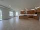 Bright living room showcasing an open layout, tile flooring, recessed lighting, and seamless transition to the kitchen area at 766 Hillshire Pl, Spring Hill, FL 34609