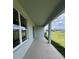 Covered outdoor patio with large windows overlooking a well-maintained backyard at 766 Hillshire Pl, Spring Hill, FL 34609