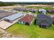 An aerial view reveals the home's setting amidst a lush green landscape within a residential neighborhood at 774 Hillshire Pl, Spring Hill, FL 34609