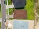 Directly overhead aerial view of a home with a russet roof and spacious lawn, nestled in a well-maintained neighborhood at 774 Hillshire Pl, Spring Hill, FL 34609