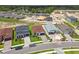 Wide aerial shot showcasing a residential street with manicured lawns, new homes, and serene surroundings at 774 Hillshire Pl, Spring Hill, FL 34609