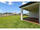Enjoy a covered patio overlooking the expansive backyard and surrounding new home construction in this growing community at 774 Hillshire Pl, Spring Hill, FL 34609
