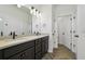 Bathroom with double vanity, dark cabinets, white quartz countertops, and a walk-in shower at 774 Hillshire Pl, Spring Hill, FL 34609