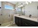Bathroom featuring a double vanity, shower, and modern lighting at 774 Hillshire Pl, Spring Hill, FL 34609