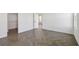 An airy bedroom with an open closet and wood-look herringbone floors at 774 Hillshire Pl, Spring Hill, FL 34609