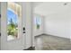 Chic home entryway with herringbone-patterned floors and an arched doorway, offering a glimpse into a bright, airy room at 774 Hillshire Pl, Spring Hill, FL 34609