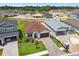 An aerial shot features a charming single-Gathering home with a manicured lawn and brick paver driveway at 774 Hillshire Pl, Spring Hill, FL 34609