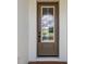 Close-up of a front door with a glass panel, elegant hardware, and a welcoming design, set in a modern home facade at 774 Hillshire Pl, Spring Hill, FL 34609