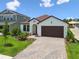 Well-maintained home boasting lush landscaping, brick driveway, and a covered entryway for added curb appeal at 774 Hillshire Pl, Spring Hill, FL 34609