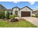 Inviting single-Gathering home with a well-kept lawn, mature trees, and a brick-paved driveway at 774 Hillshire Pl, Spring Hill, FL 34609