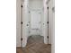 Hallway with herringbone-patterned floors and white doors with black hardware at 774 Hillshire Pl, Spring Hill, FL 34609