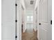 Hallway with white doors and views of a bedroom and sunlit living space at 774 Hillshire Pl, Spring Hill, FL 34609