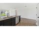 Open-concept kitchen with stone countertops and stainless-steel appliances at 774 Hillshire Pl, Spring Hill, FL 34609