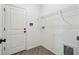 Laundry room featuring white wire shelving, a white door, and wood-patterned floors at 774 Hillshire Pl, Spring Hill, FL 34609