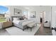 A bright, virtually staged primary bedroom featuring modern decor, neutral colors, and an ensuite bathroom at 774 Hillshire Pl, Spring Hill, FL 34609