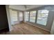 Florida room with wood-look tile floors, multiple windows, and access to backyard at 9612 Valencia Cv, Bradenton, FL 34210