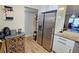Kitchen area with stainless steel refrigerator and wood-look tile floors at 9612 Valencia Cv, Bradenton, FL 34210
