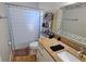 Bathroom with granite countertop, updated vanity, and shower/tub combo at 9612 Valencia Cv, Bradenton, FL 34210