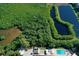 Aerial view of the community pool, tennis courts, and waterways at 9612 Valencia Cv, Bradenton, FL 34210
